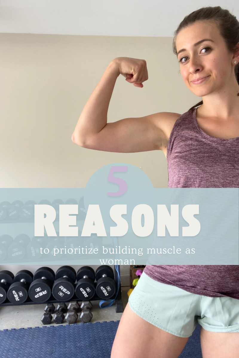 woman flexing bicep in purple workout tank with dumbbells in the background