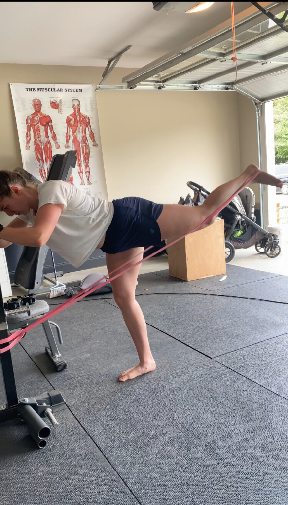 Garage gym training with personal trainer in Cornelia, Georgia—banded kickbacks for glute strength